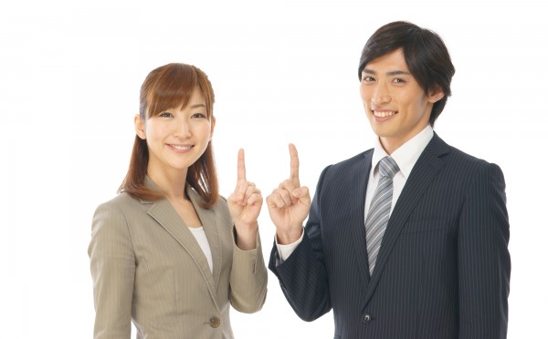 指で一を示す男性と女性
