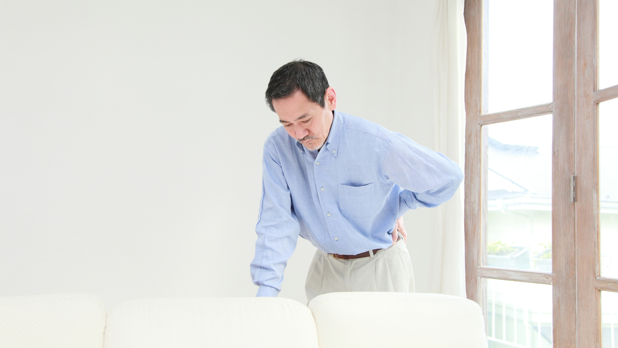 腰痛を気にする男性