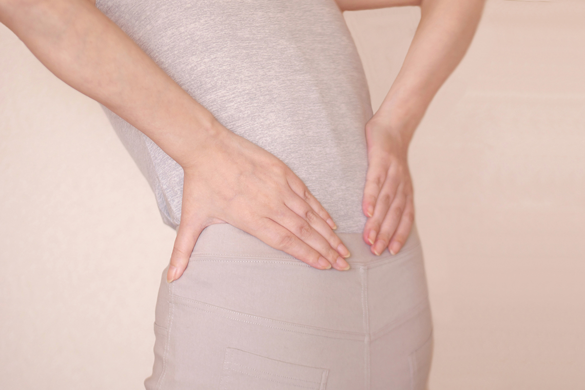 腰に手を当てる女性